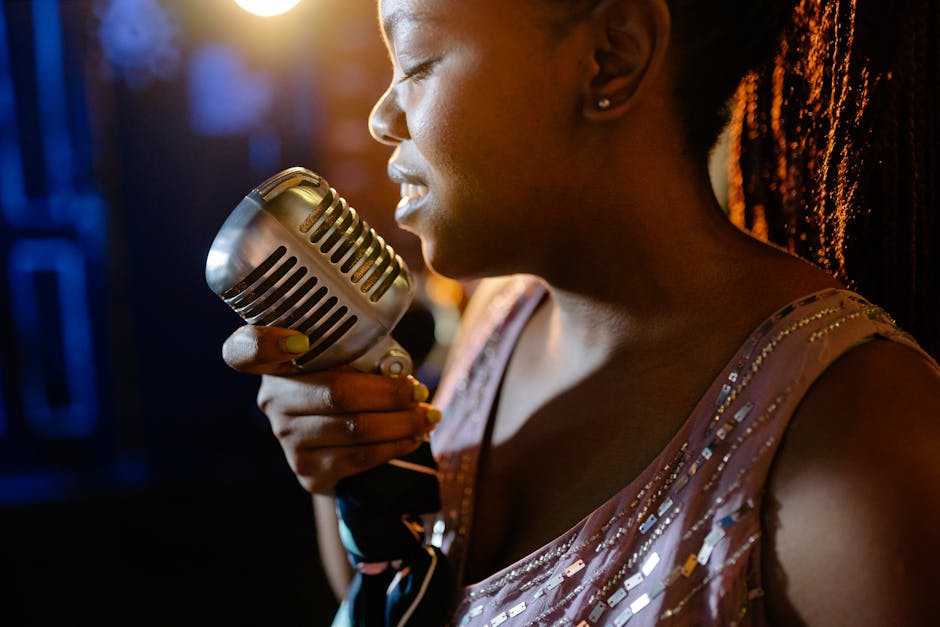 Close-up of a woman passionately singing jazz on stage with a vintage microphone.