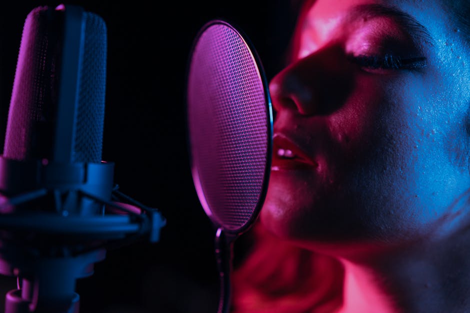 A dynamic shot of a woman singing into a microphone with vibrant lighting.
